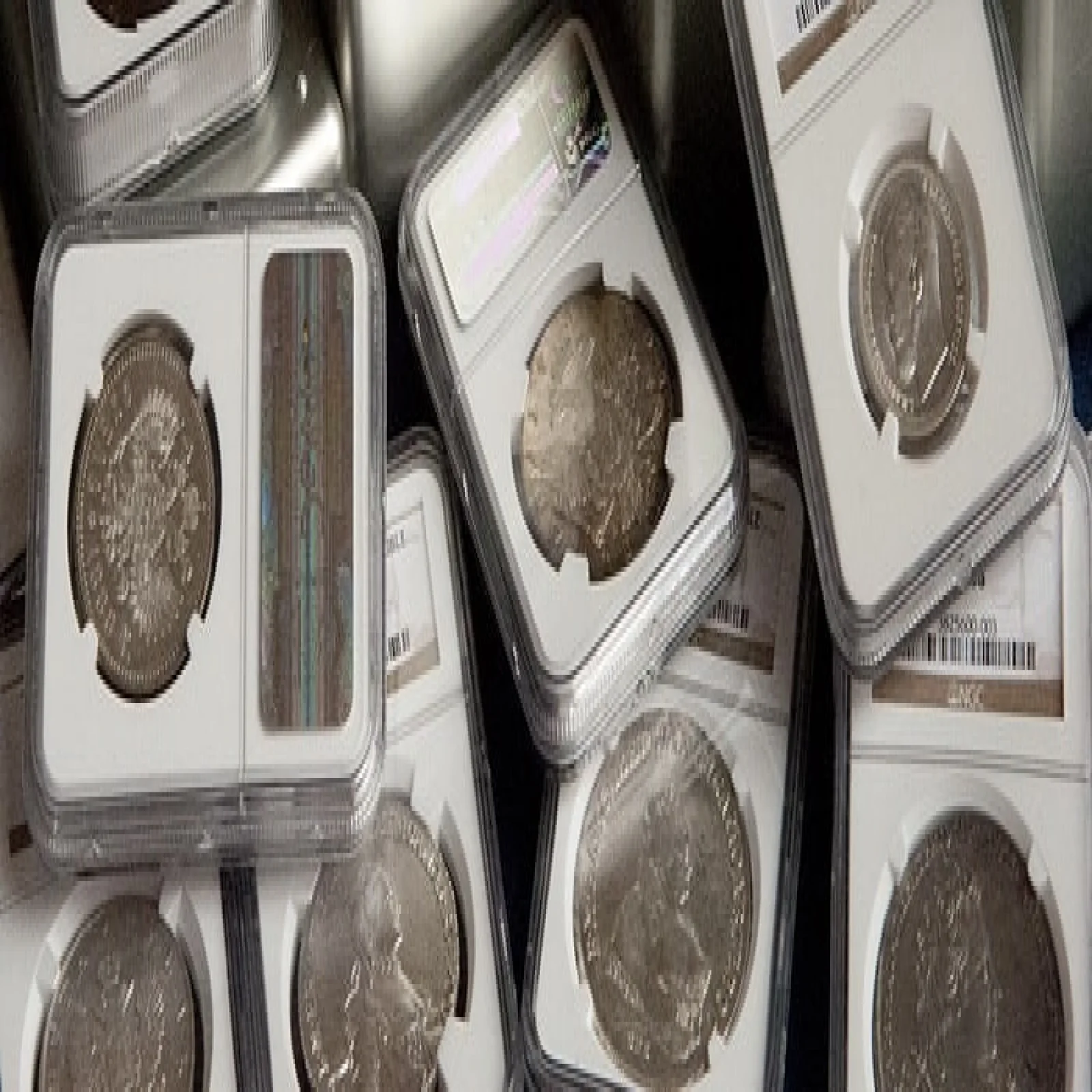 Encapsulated coin beside a rare banknote and inspection loupe