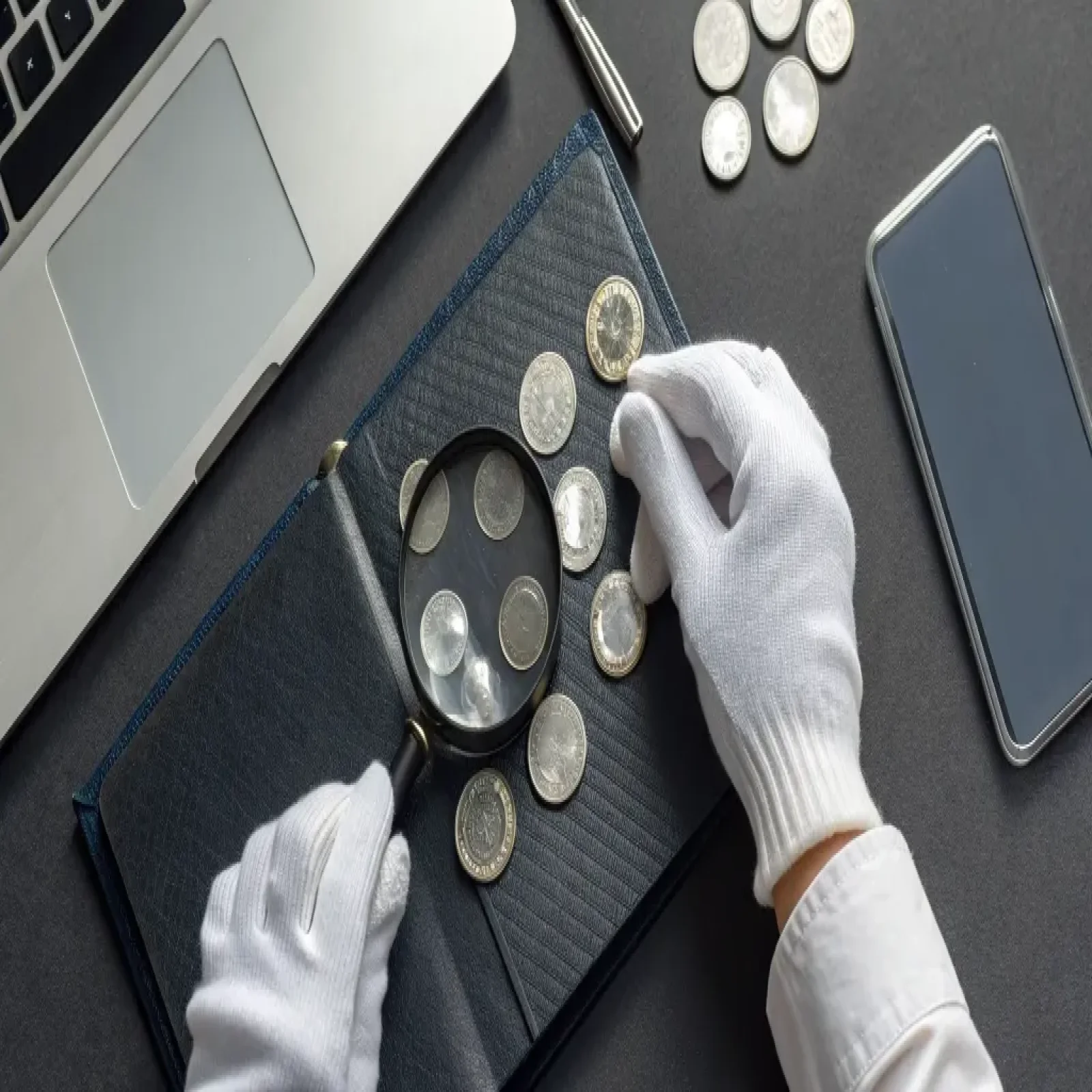 Checklist and magnifier beside a coin and banknote listing card